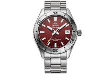 Silver wristwatch with a red face on a white background