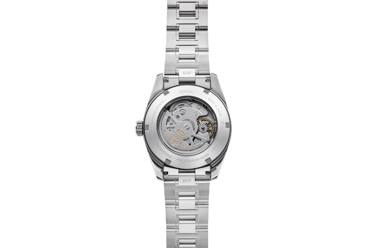 A stainless steel wristwatch shown from the back, featuring a transparent case back that reveals a detailed mechanical movement with gold and purple accents.

Orient Star RE-AU0109L