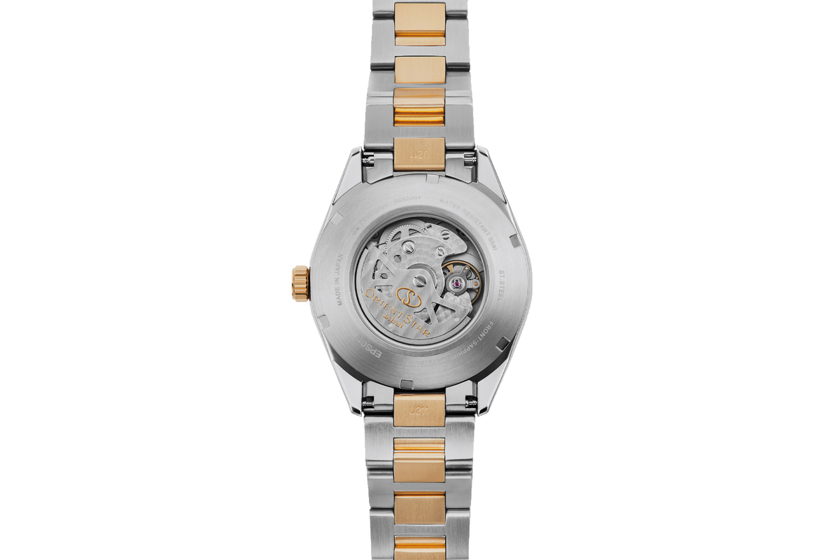 A two-tone stainless steel and gold wristwatch shown from the back, featuring a transparent case back that reveals the intricate mechanical movement inside.
 
Orient Star RE-AU0405E